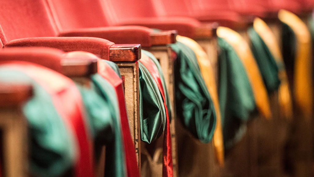 Graduation gowns on chairs 