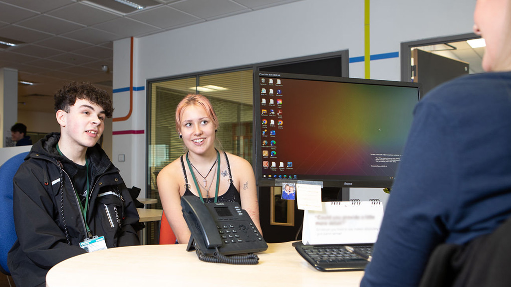 Two students talking to a College advisor