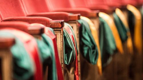 Graduation gowns on chairs 