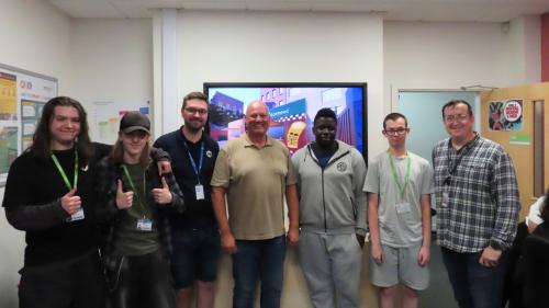 Photo of four Digital Industries students with Hey Service Group and Nick, Digital Industries lecturer. 