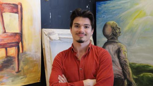 BA (Hons) Art & Design student, Burga, with his artwork at the end of year show at Selby College, 2025.