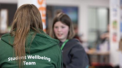 Wakefield College Student Wellbeing Team speaking with student. 