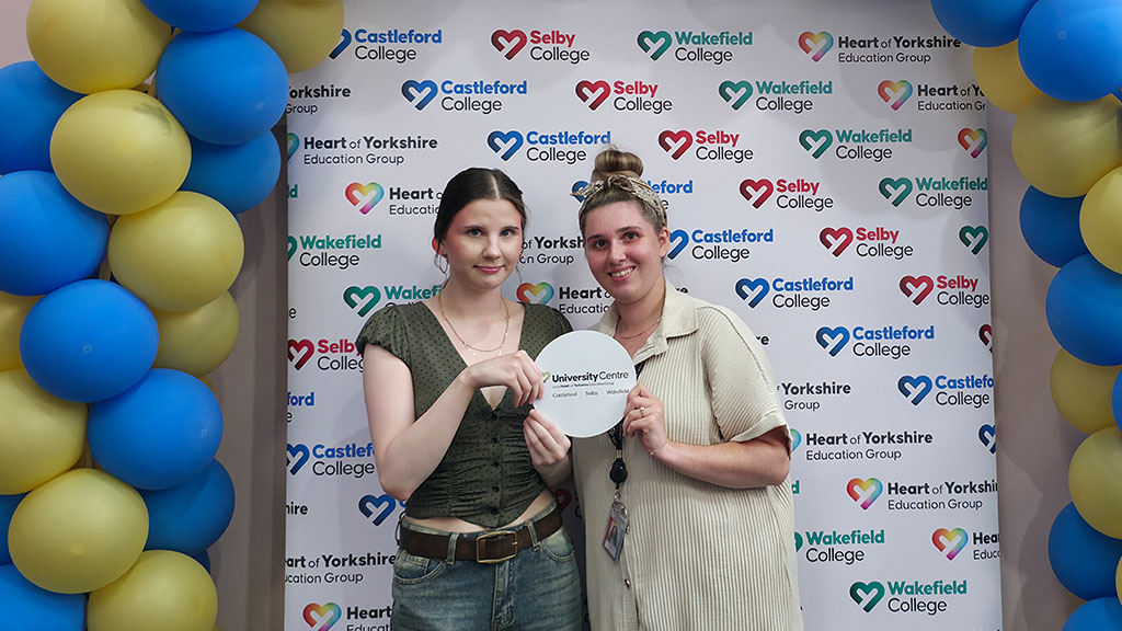 Student with sister and university logo