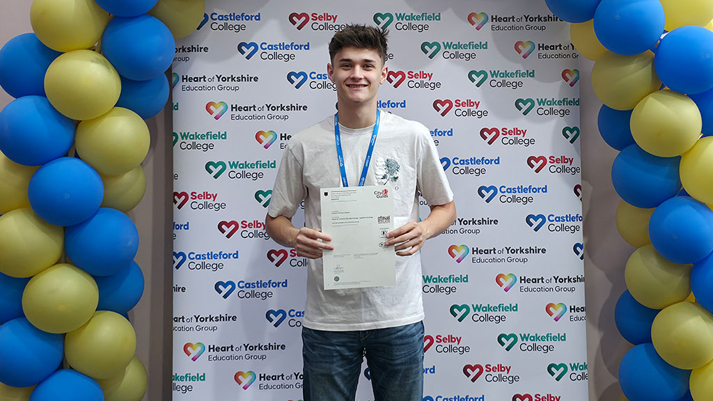 Student holding certificate