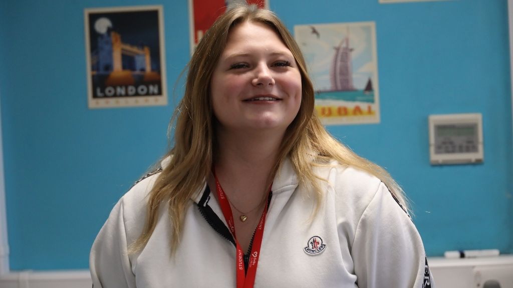 Student smiling in classroom 