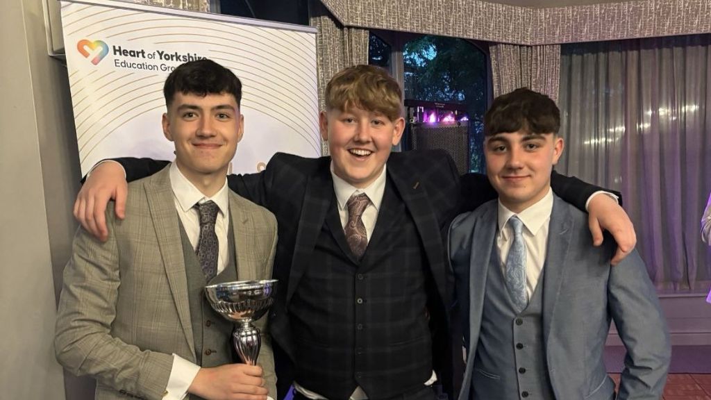 Students holding trophy