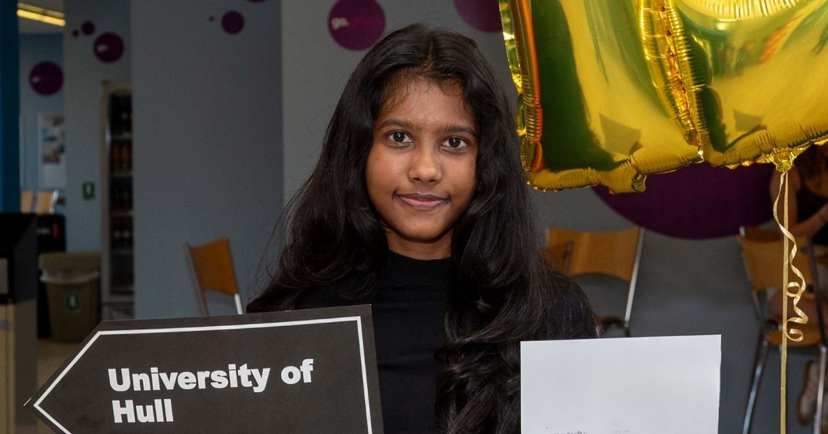 Bimadi holding up her university destination 