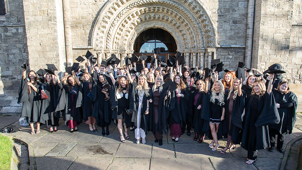 Selby College graduates celebrating outside Selby Abbey
