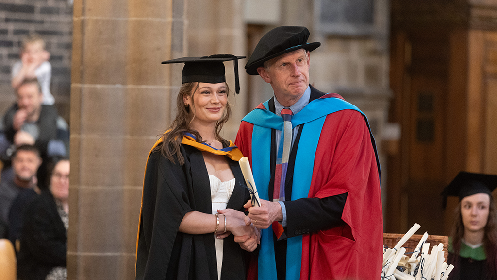 Graduate collecting their scroll