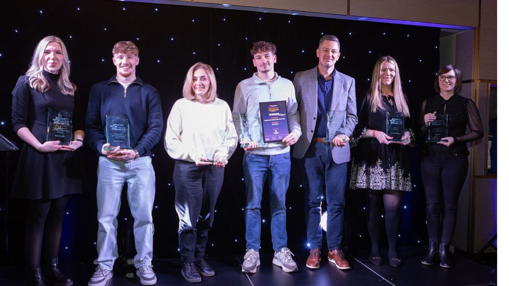 Award winners holding plaques