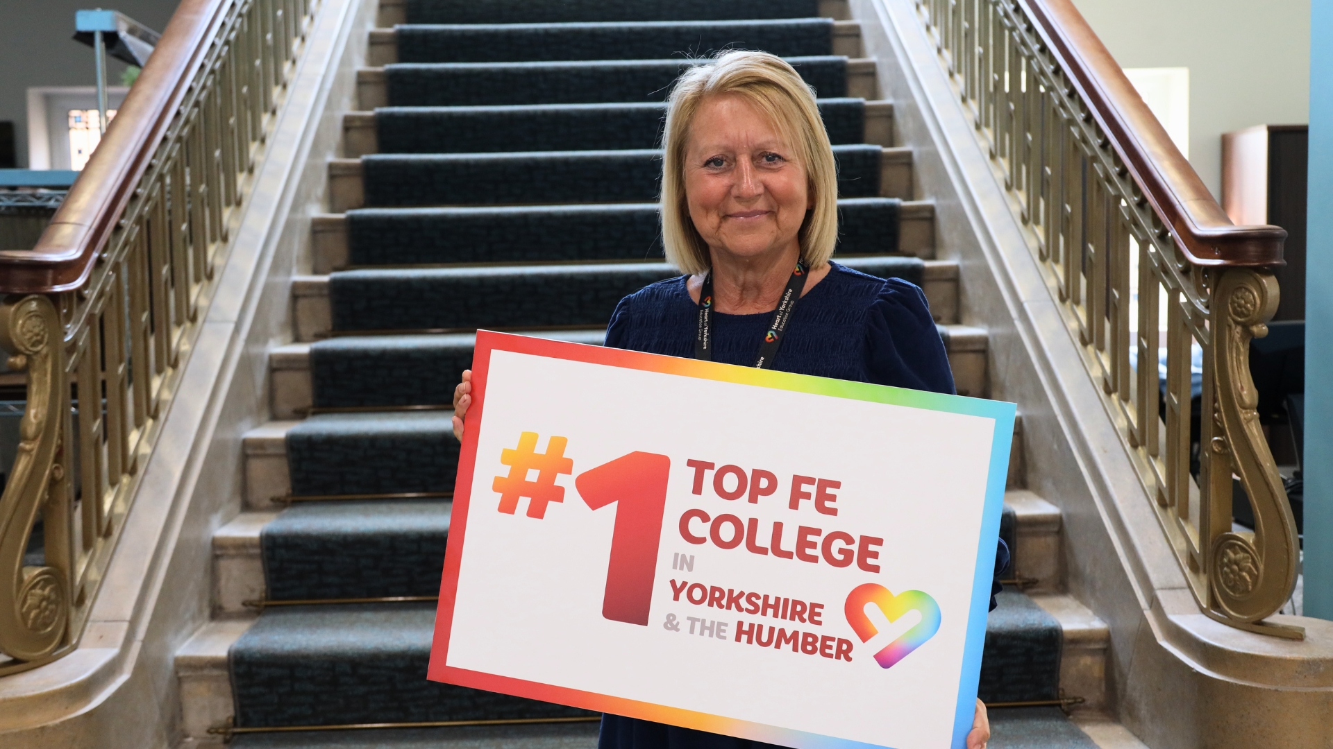 Sam Wright, Principal and Chief Executive at the Heart of Yorkshire Education Group holding up a Top FE College sign